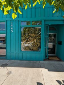Branded window graphics on retail storefront glass, enhancing visibility and promoting services and sales