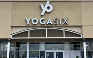 Illuminated channel letter sign mounted on a storefront facade to enhance business visibility.