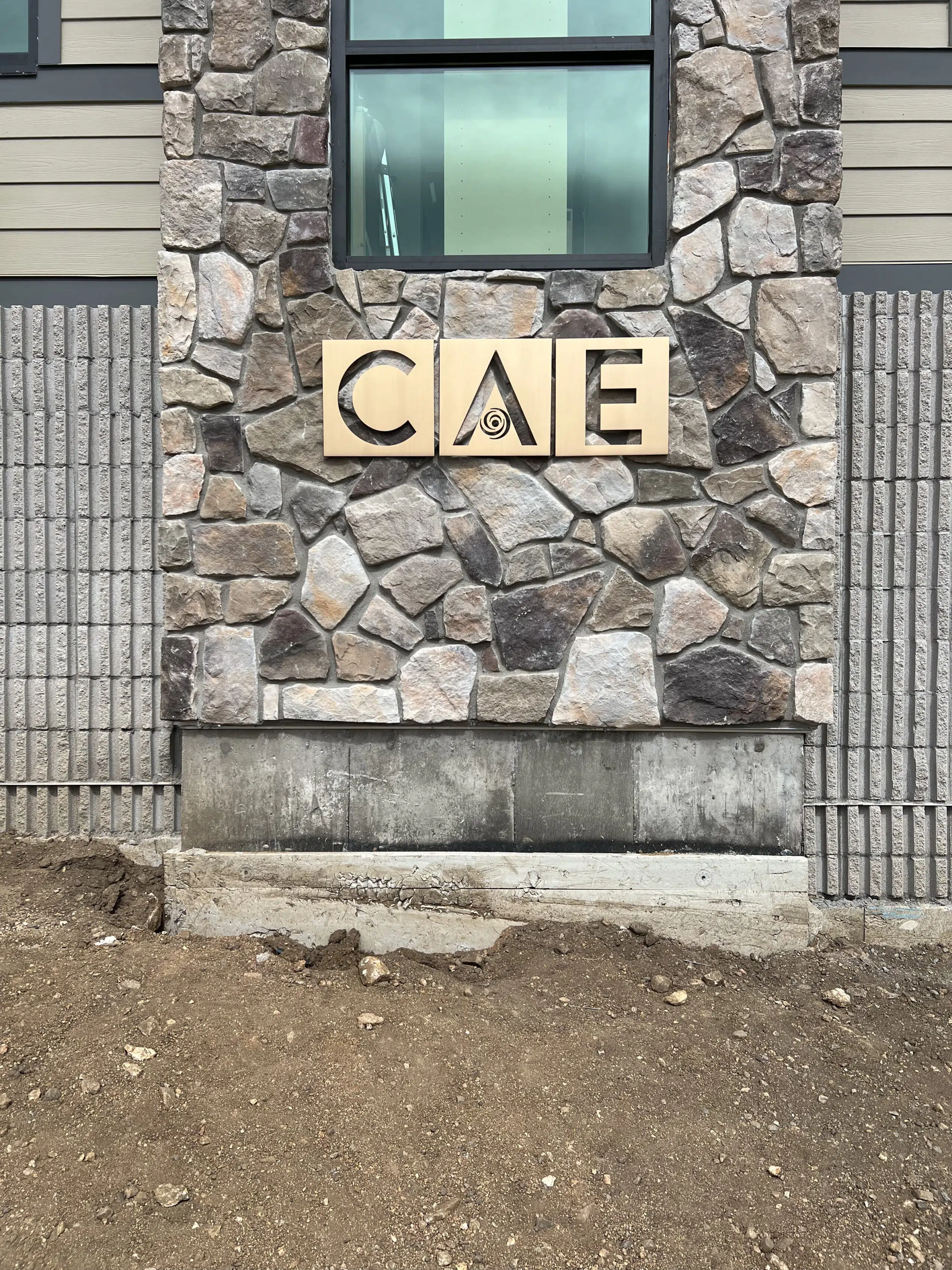 Evergreen metal letter installed outdoors, demonstrating durable, weather-resistant signage materials