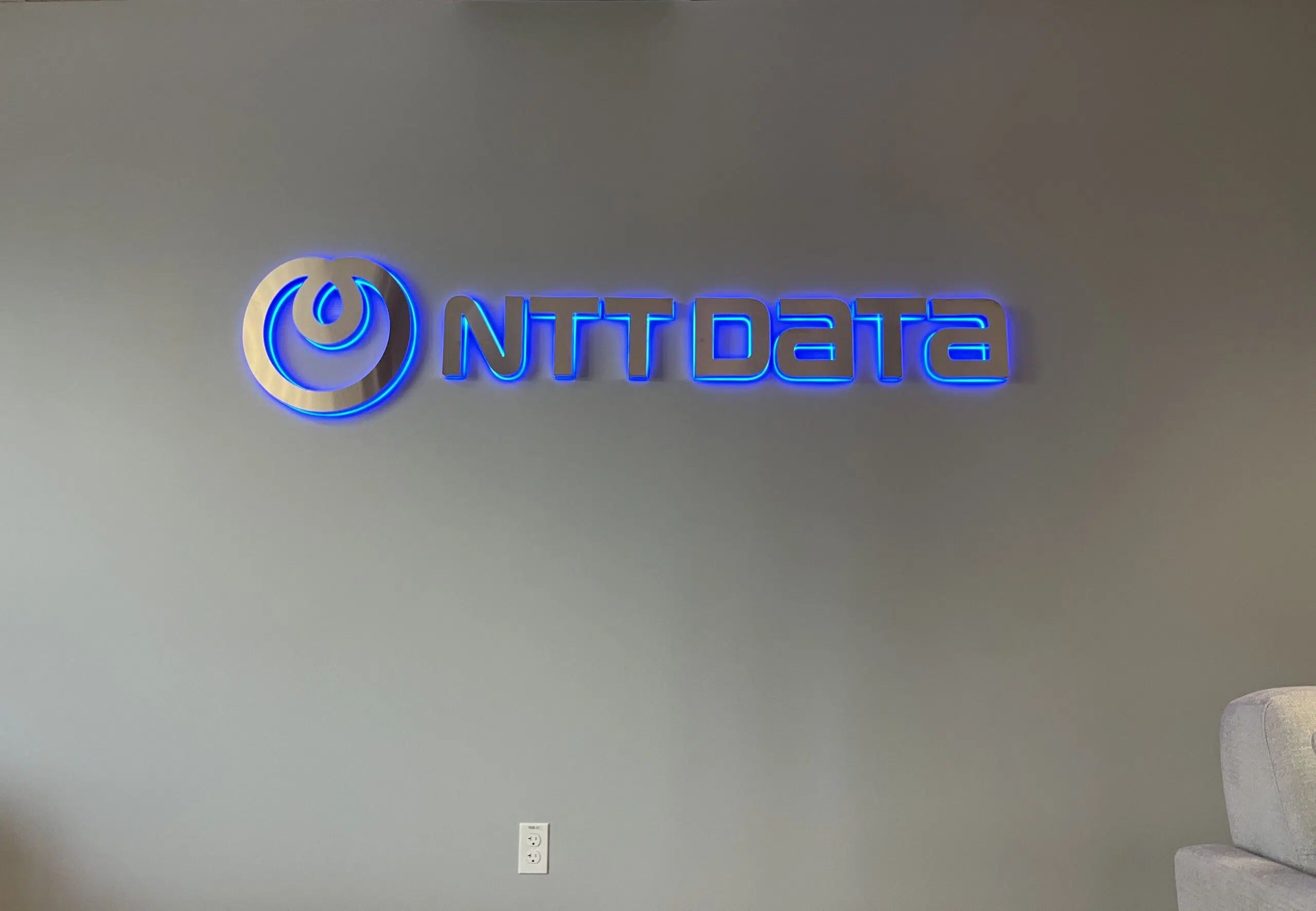 Halo-lit lobby sign in modern Denver corporate office with LED backlighting creating sophisticated glow effect