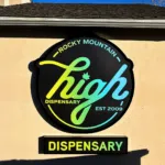 Illuminated exterior wall sign for Rocky Mountain High Dispensary mounted on a commercial building facade.
