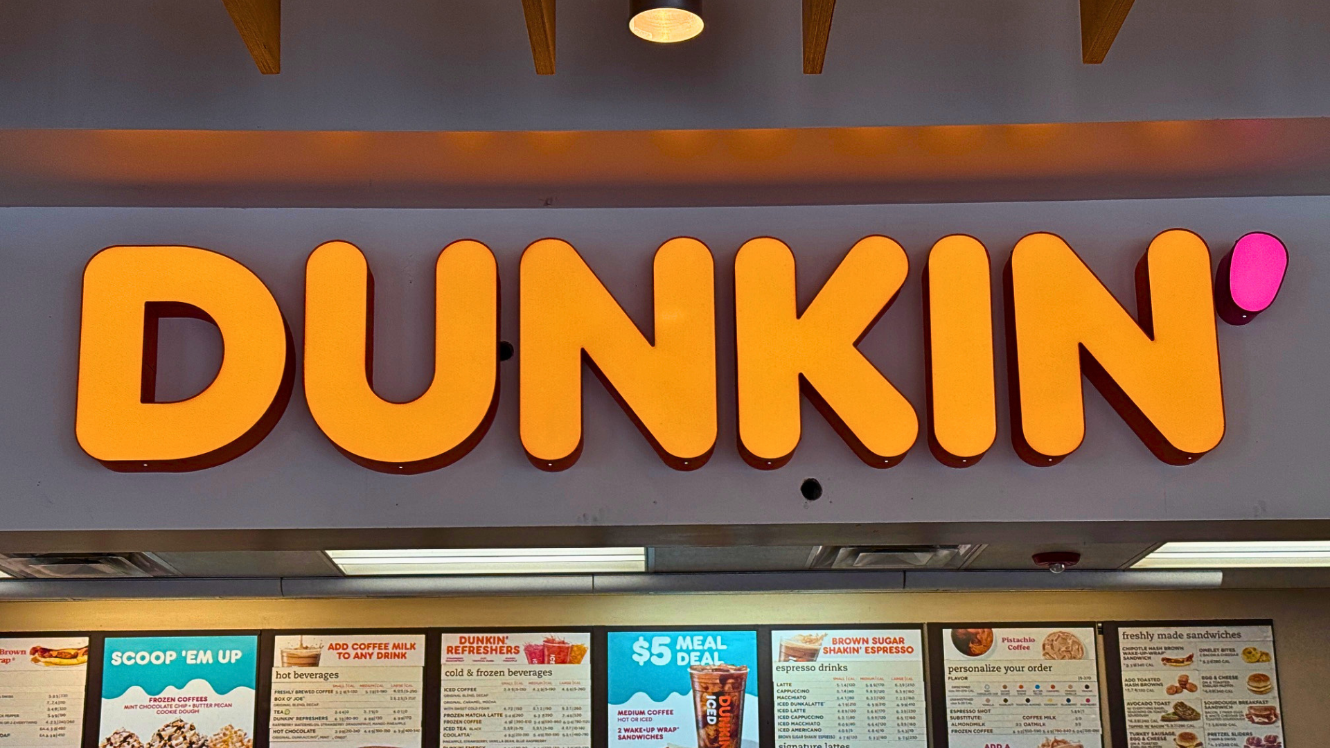 Illuminated channel letter storefront sign on a modern retail building in Denver, Colorado, demonstrating one of the most effective business sign types for attracting customers.