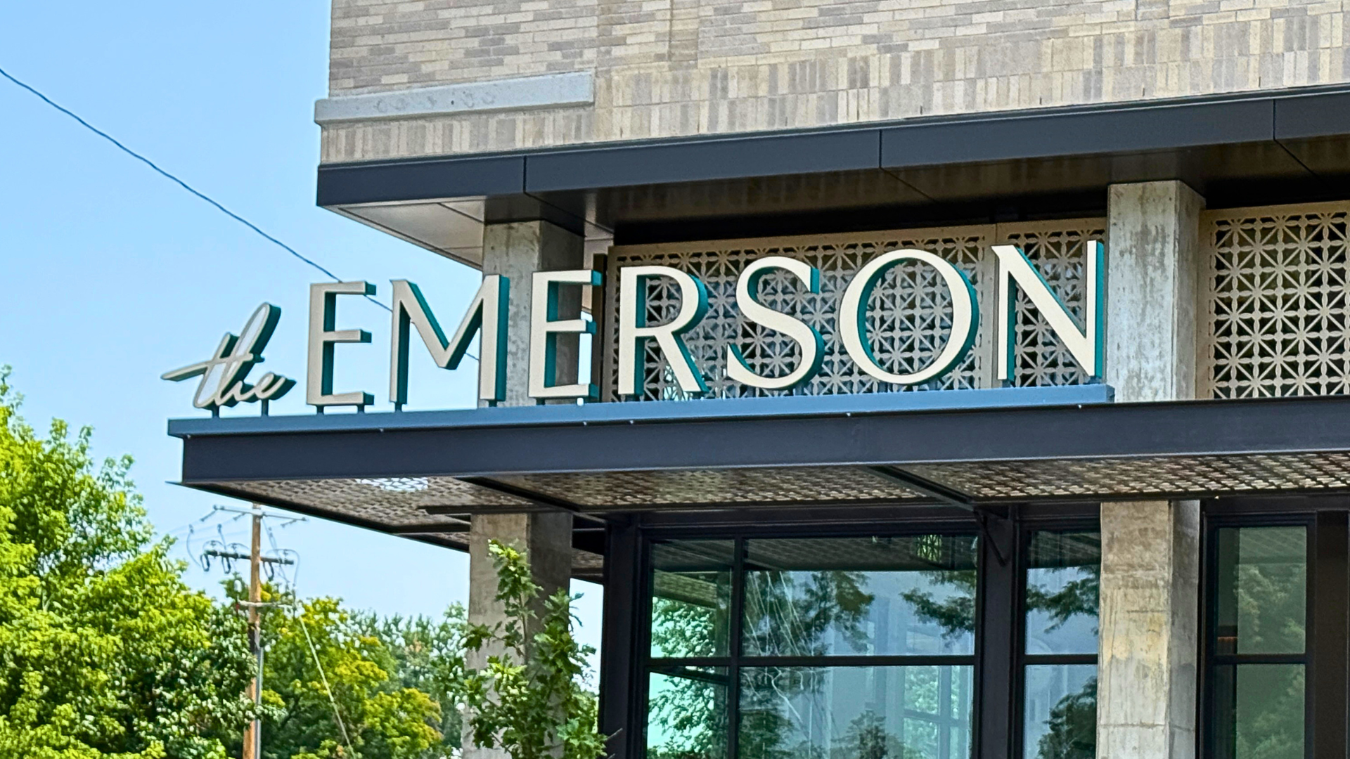 Illuminated channel letter building sign installed on a modern commercial office building in Denver, Colorado, providing high visibility and professional branding.