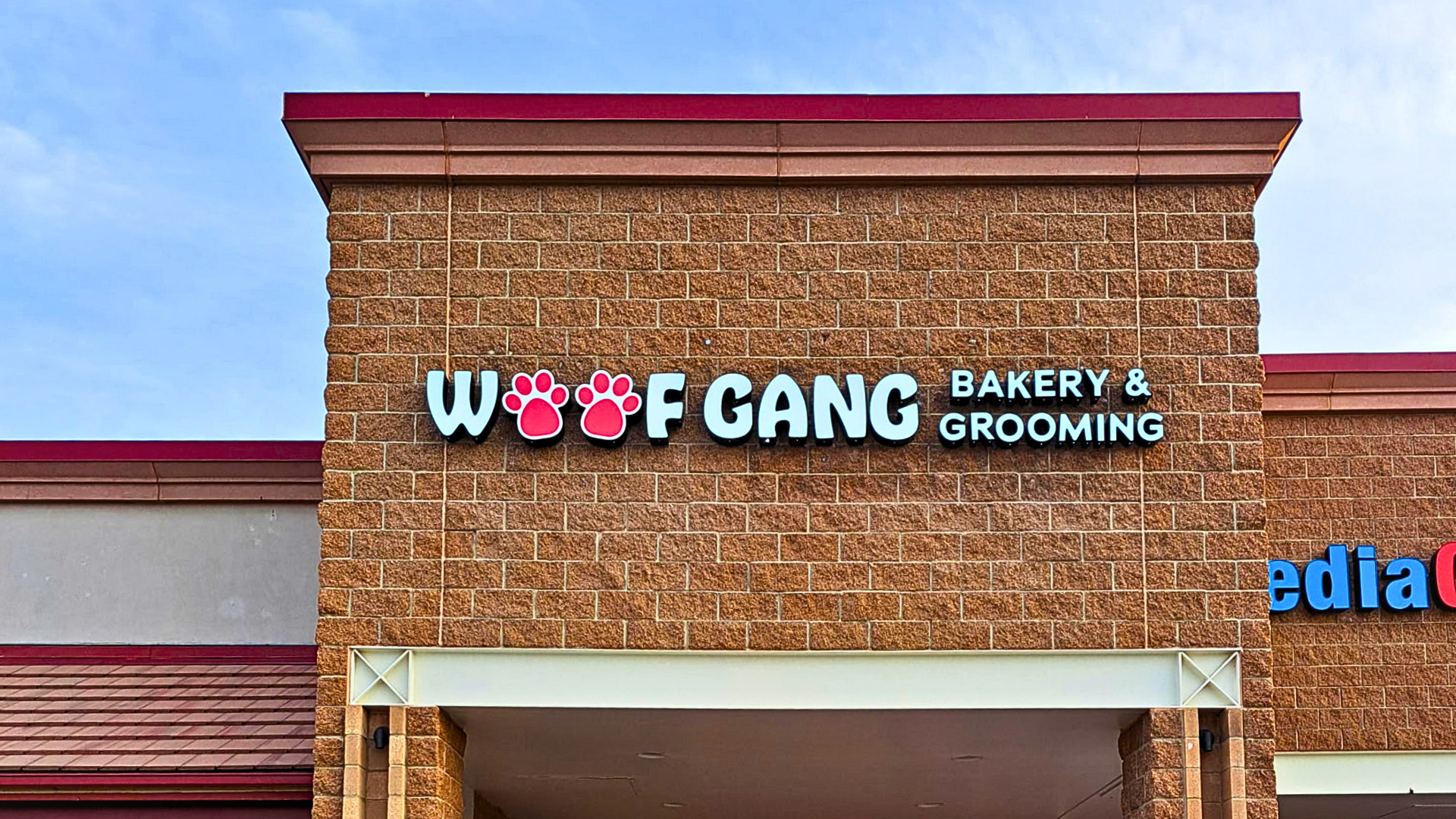 Custom illuminated storefront channel letter sign installed on a Denver retail shopping center, helping a business attract customers with bold, highly visible exterior branding.